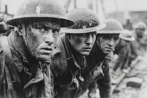 World War I soldiers in muddy trenches wearing helmets and gas mask straps, exh, a Photo by AS photostudio