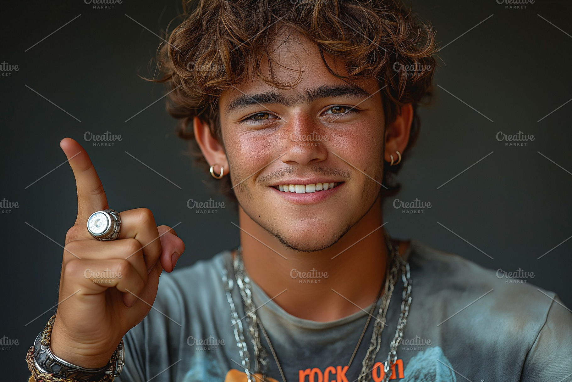 Young Caucasian male with curly hair smiles and gestures with his finger raised, a Background Photo by ImageMir
