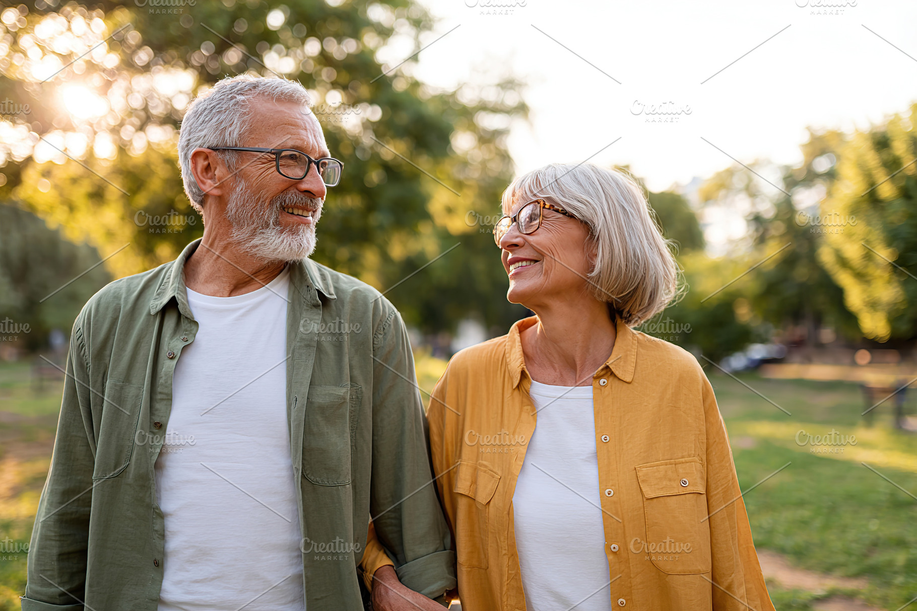 Couple enjoys a stroll in a green park during a sunny evening, a Person Photo by AlyaAnd