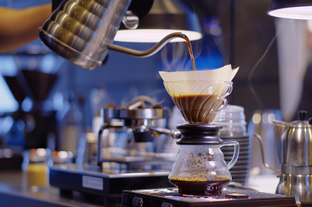 A person is pouring coffee into a co, a Photo by Iftikhar Alam