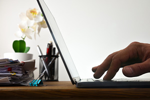Hand Typing on Laptop Beside Paperwork, a Business Photo by Davizro's Market