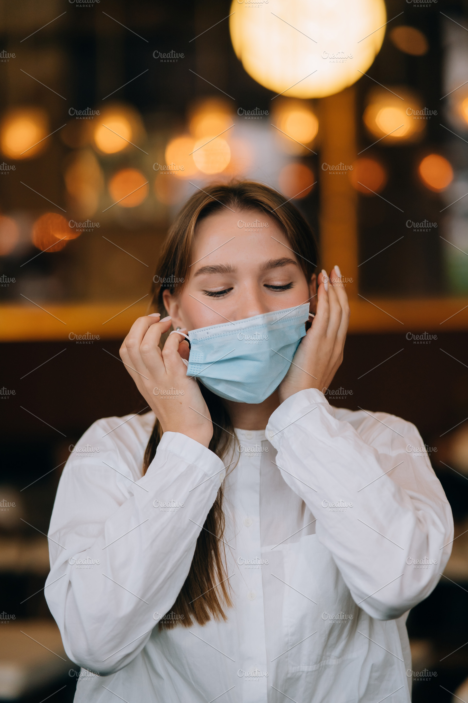 Girl in takes off her protective medical face mask, a Person Photo by Tekso