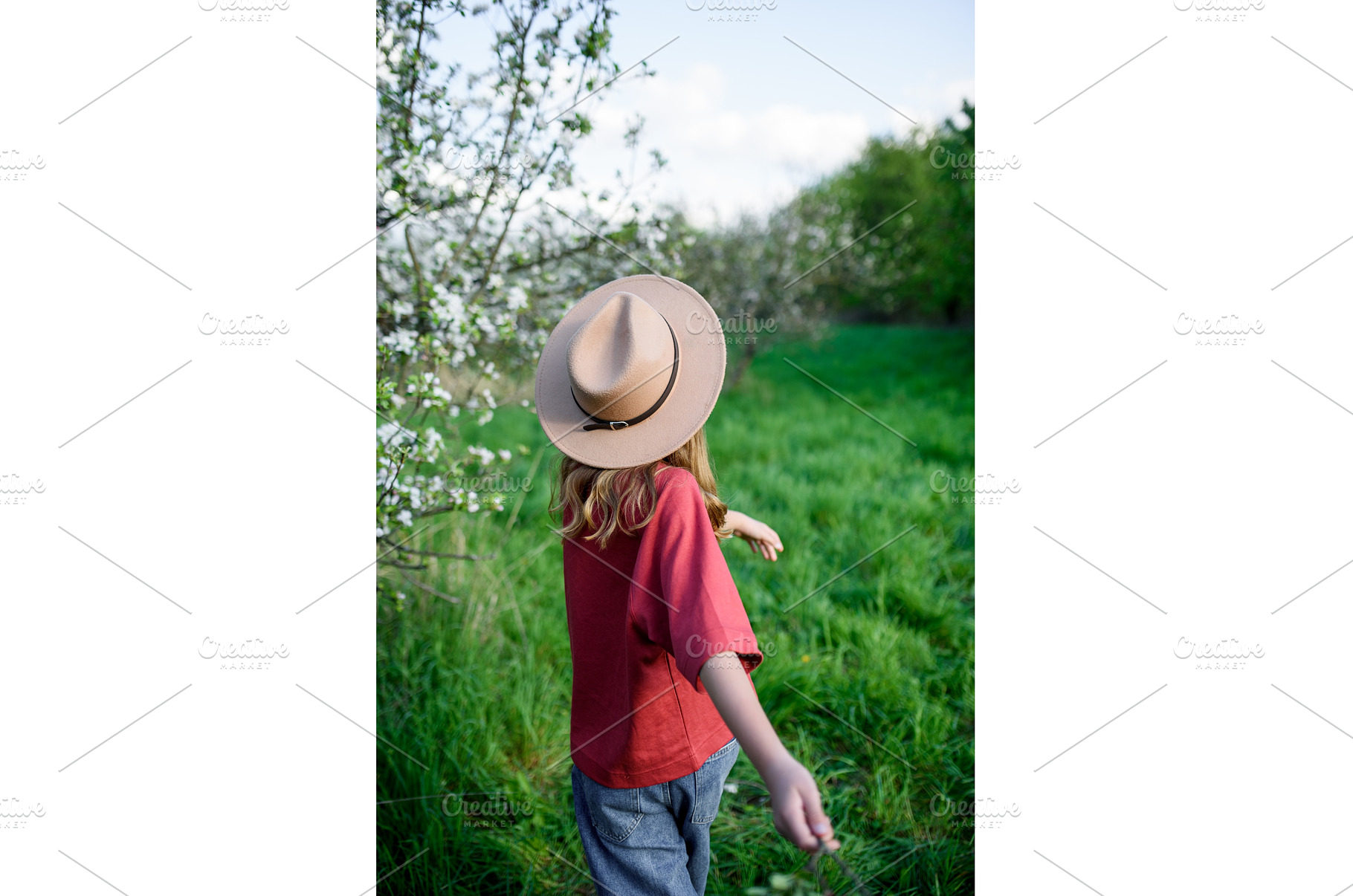 Rear view of girl in hat standing in, a Nature Photo by HalfPoint