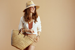 smiling elegant woman in blouse and shorts on beige, a Person Photo by Alliance Images