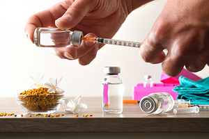 Nurse loading a syringe with vaccine for pollen allergies, a Health & Medical Photo by Davizro's Market