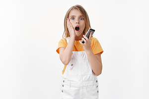 Shocked girl hold mobile phone