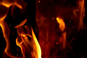 Intense tongues of orange and yellow flame, small glowing sparks, an Abstract Photo by ndanko