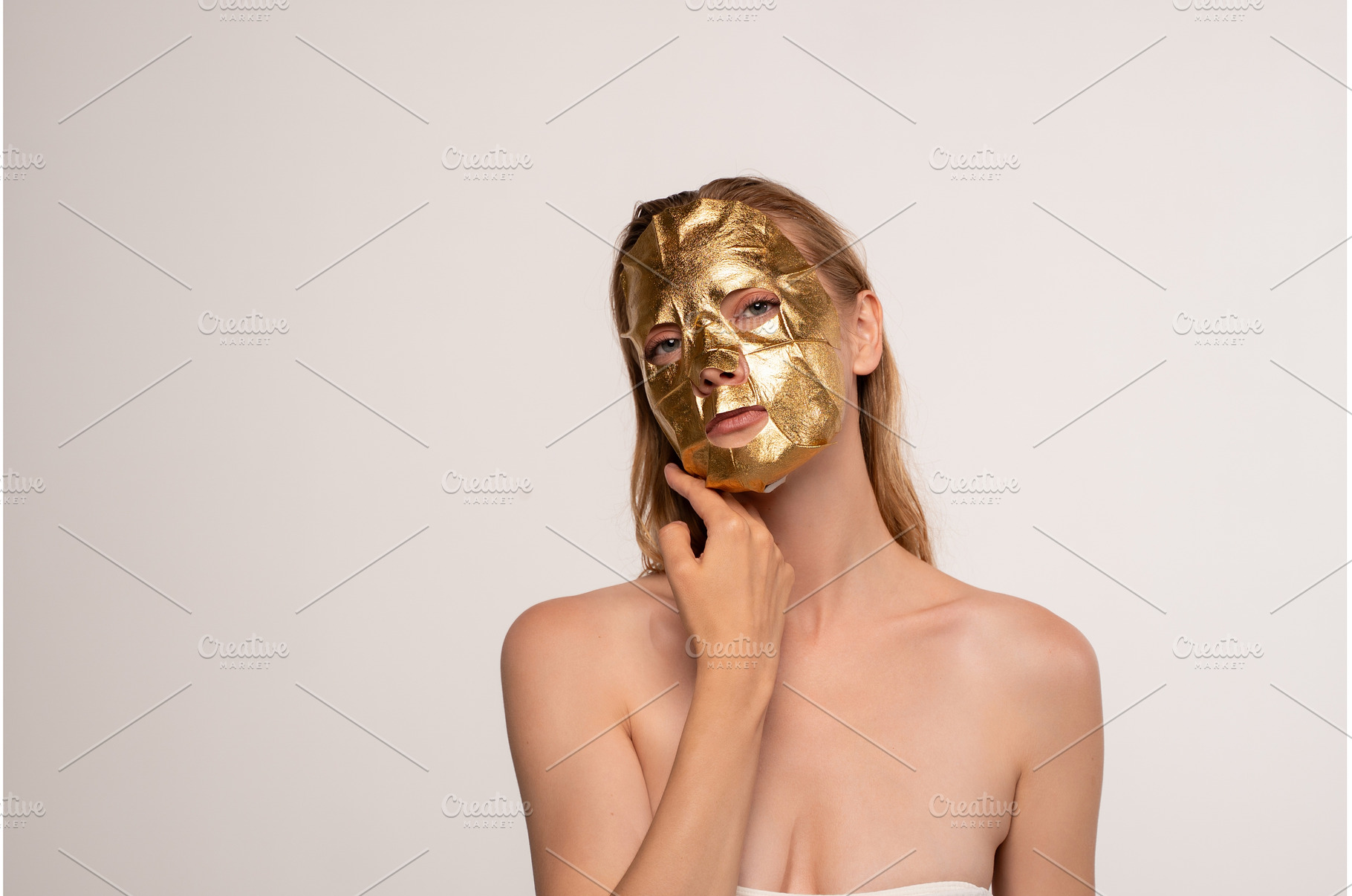 Woman applying gold face mask for, a Beauty & Fashion Photo by volodymyrshtun13795