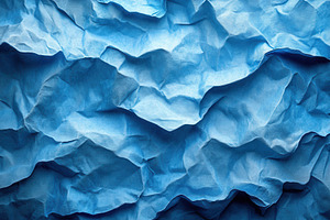 Crumpled blue paper creating texture, a Photo by Tanuart