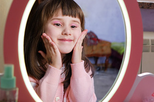 Happy little girl admiring her makeup in a toy mirror and smiling., a Person Photo by Rohan Photography
