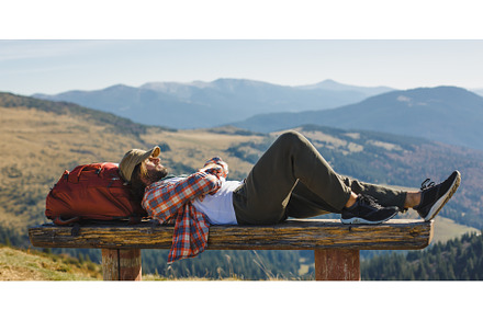 Male Hiker Resting on Top of the