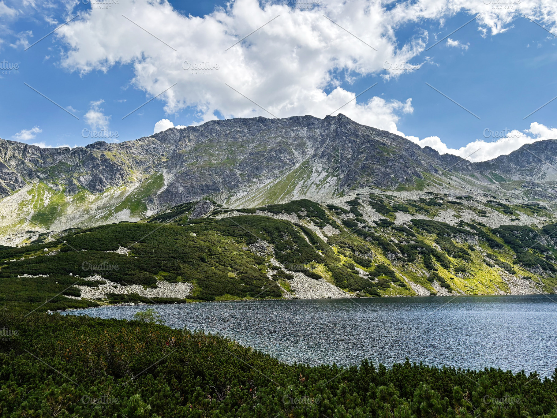 Scenic mountain lake near Zakopane Poland with rocky peaks and green slopes und, a Nature Photo by AS photostudio