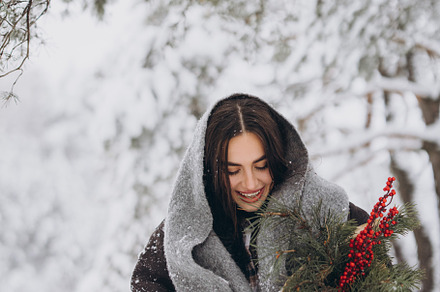 Happy woman holding winter bouquet, a Holiday Photo by Cherkas Photography