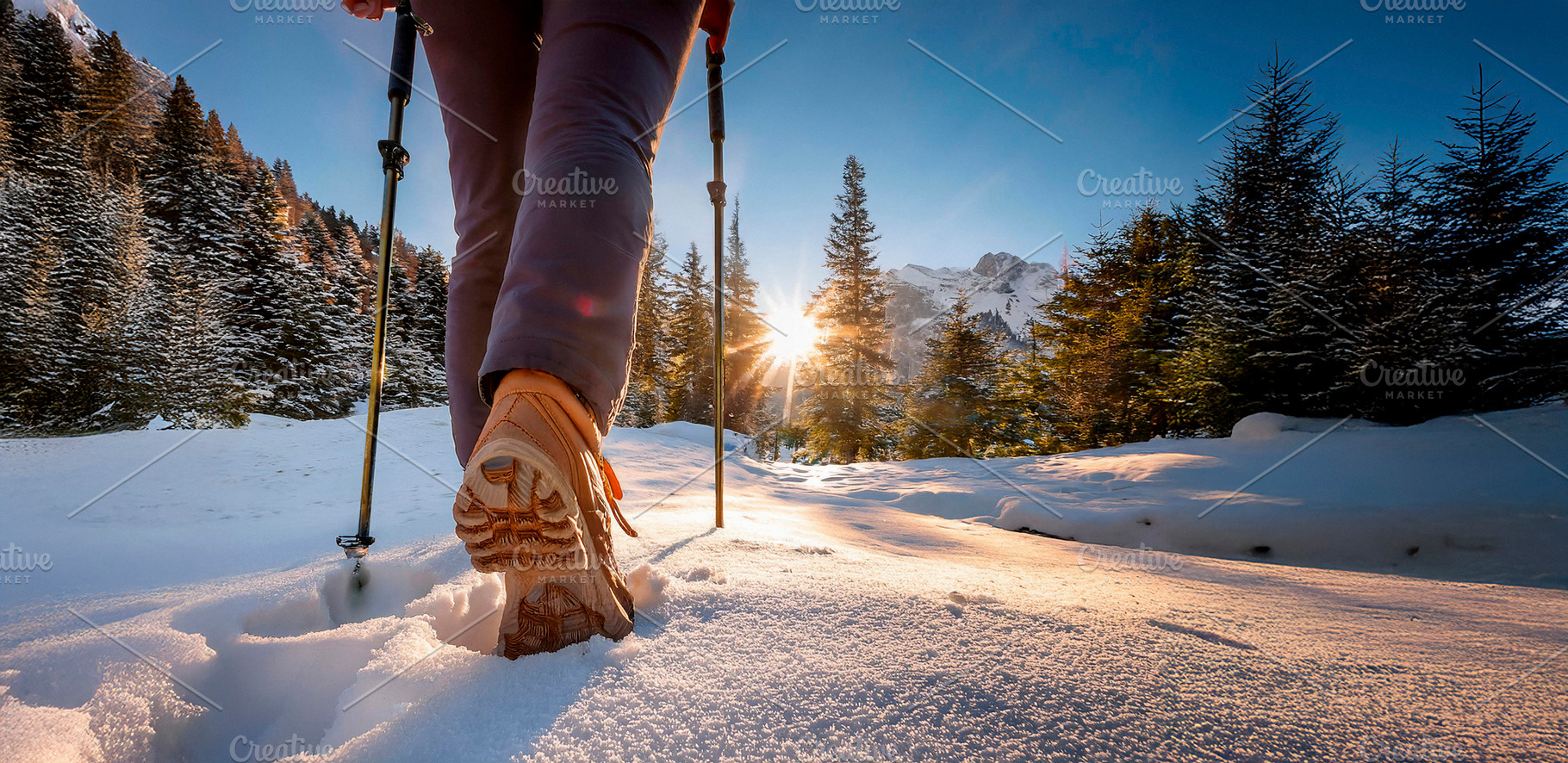 Legs of mountaineer walking through the snow at dawn., a Sports & Recreation Photo by Davizro's Market