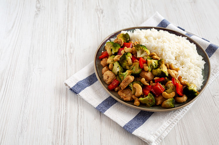 Homemade Cashew Chicken Stir-Fry on a Plate, side view. Copy spa, a Food & Drink Photo by LiudmylaChuhunova