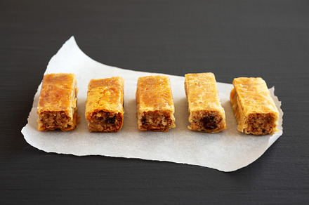 Homemade Baklavas with Honey, Chocolate and Almond on a black ba, a Food & Drink Photo by LiudmylaChuhunova