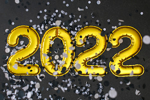 New Year 2022. Foil balloons numbers 2022 black background. New Year Christmas.