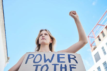 Power to the people, woman protest and freedom sign to fight human rights, justice and politics in street rally. Girl power, feminism revolution and poster to support equality, community and society, a Photo by Peopleimages.com
