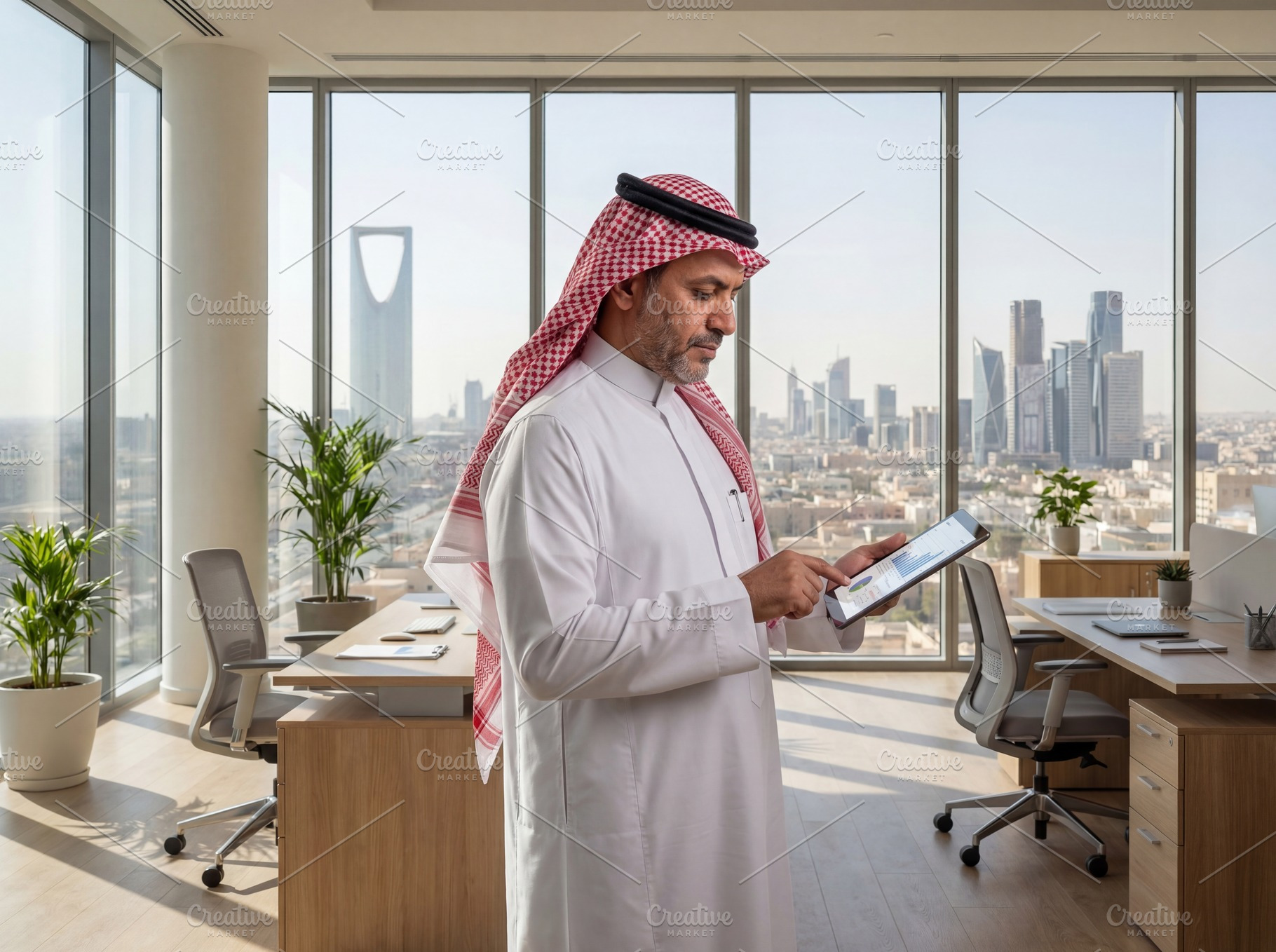 Saudi Businessman Working in a Moder, a Business Photo by Taiffco
