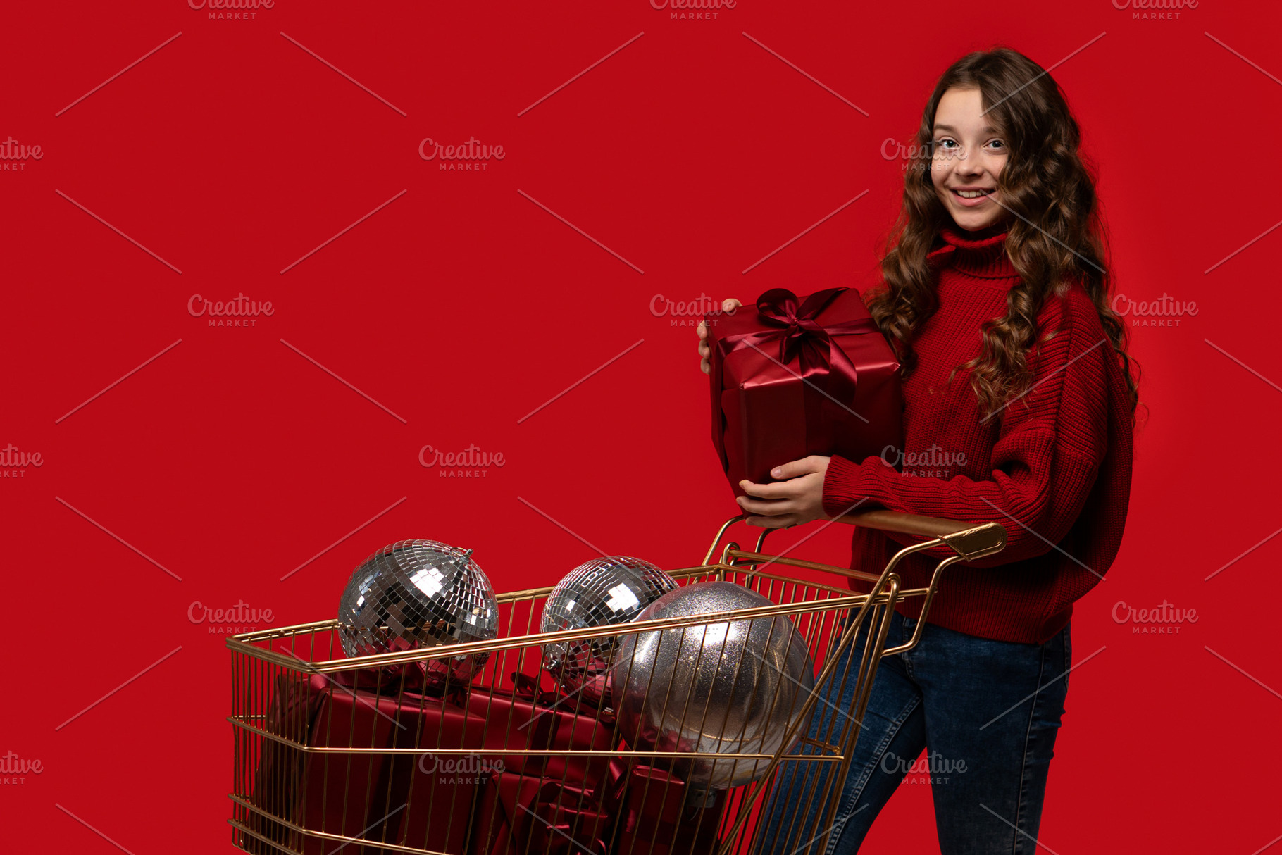 Smiling girl holds gift next to shop, a Holiday Photo by Elena Vagengeim