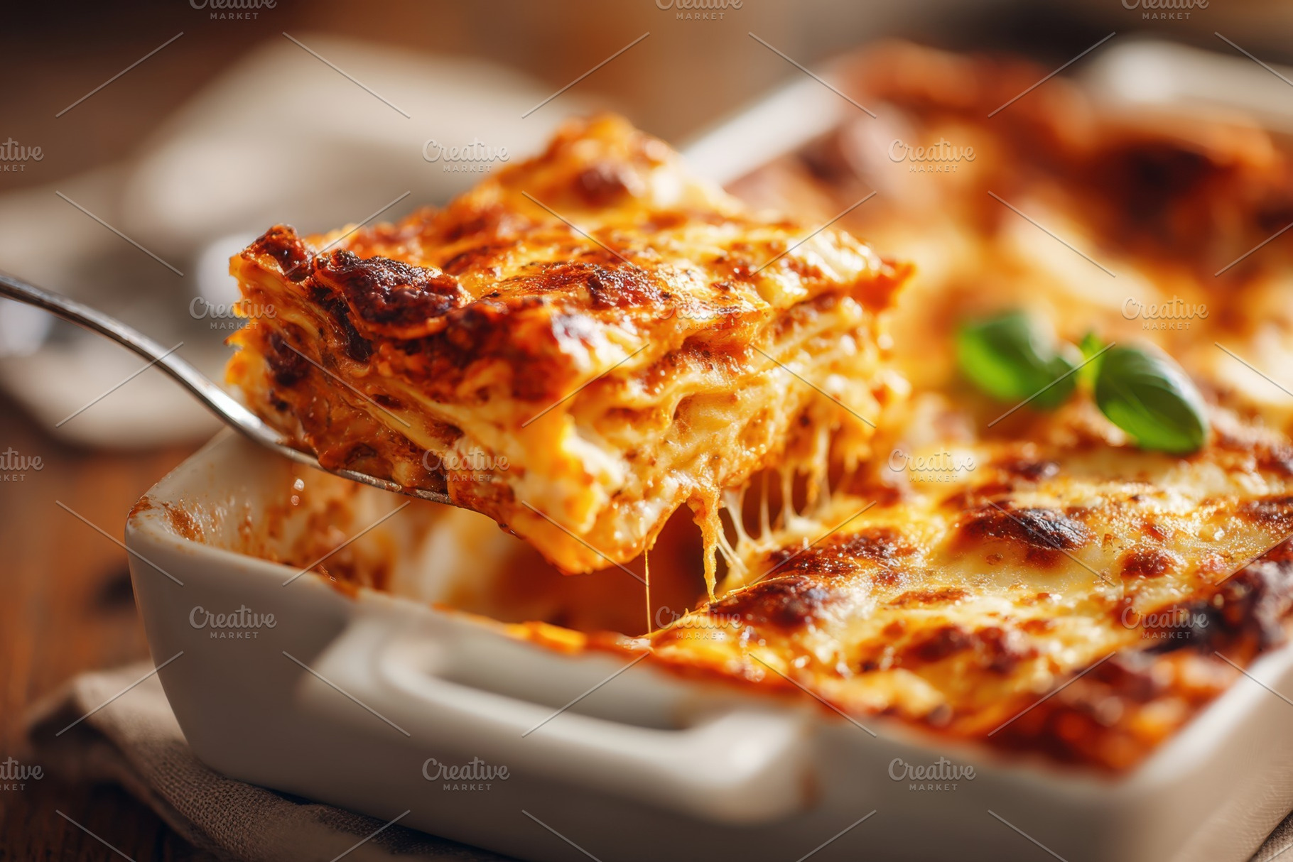 Delicious homemade lasagna with melted cheese, a Food & Drink Photo by AlyaAnd