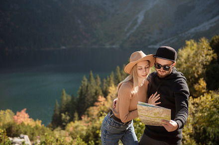 Young tourist couple, man and woman, on hiking path in mountains, a Person Photo by Olena Rudo