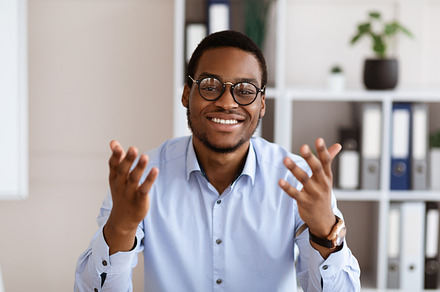 Portrait of african american business coach talking and gesturing, a Photo by Prostock-Studio