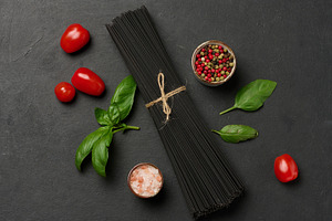 Black spaghetti, sprig of fresh basil, cherry tomatoes, pepper m, a Food & Drink Photo by ndanko