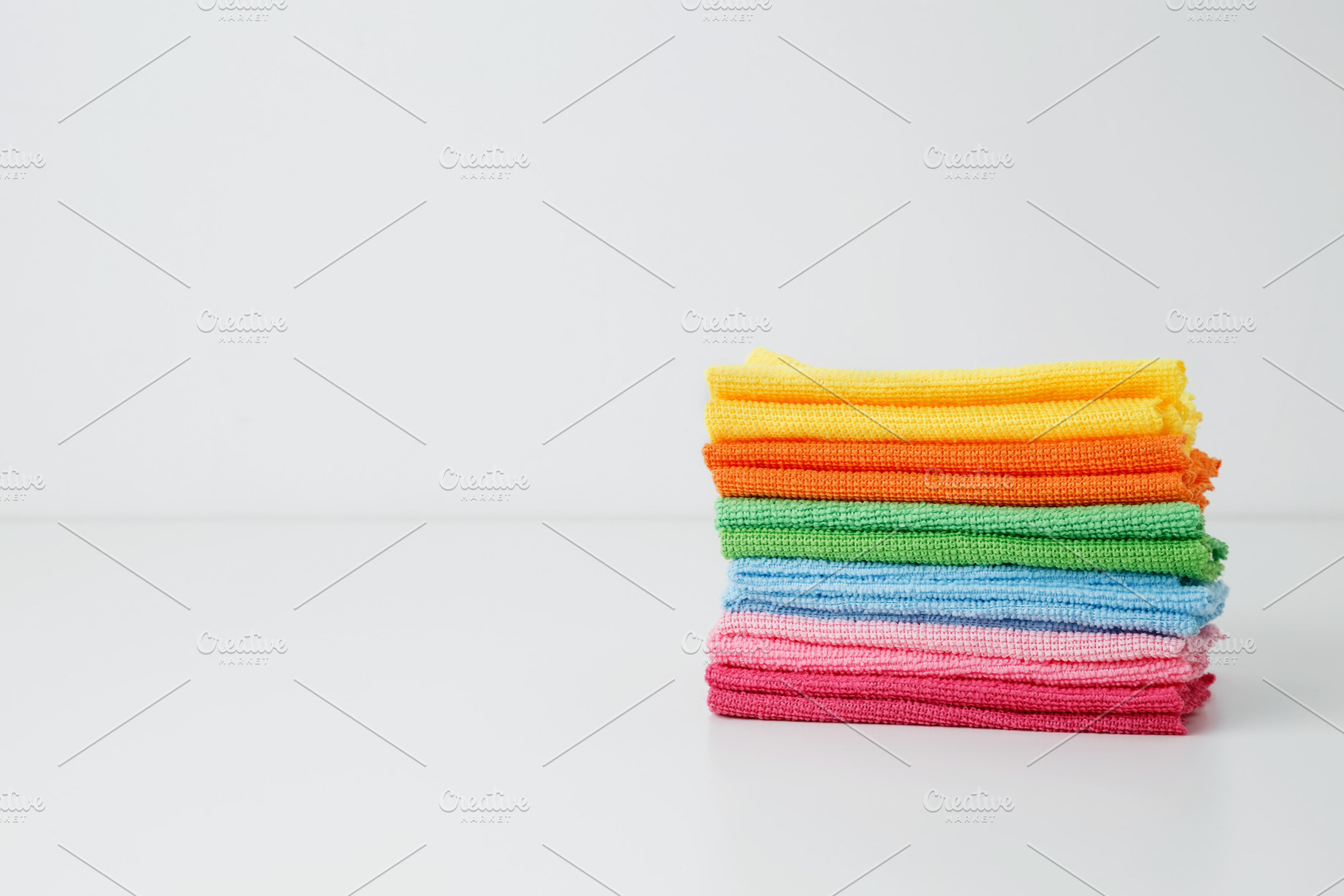 Colorful cleaning cloths neatly arranged, bringing brightness and energy to spr, a Photo by matucha
