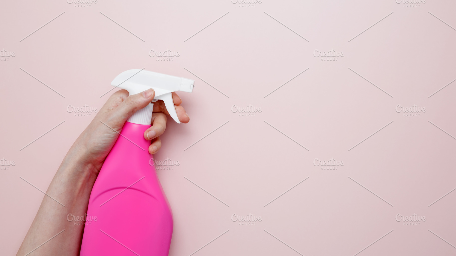 Household cleaning and hygiene concept. A womans hand holds the pink product in, a Photo by matucha