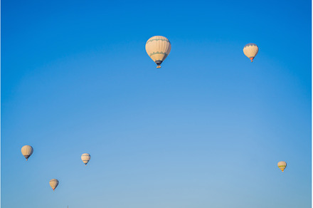 Beautiful hot air balloons over blue, a Transportation Photo by Elizaveta Galitskaya