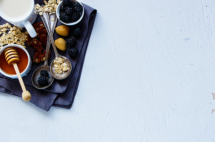 Healthy breakfast background stock photo containing almond and berry, a Food & Drink Photo by Yuliya Gontar