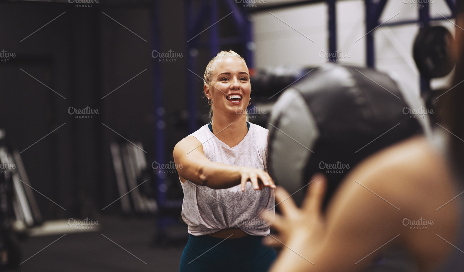 Smiling woman exercising with a partner using a medicine ball, a Sports & Recreation Photo by Stefan & Janni