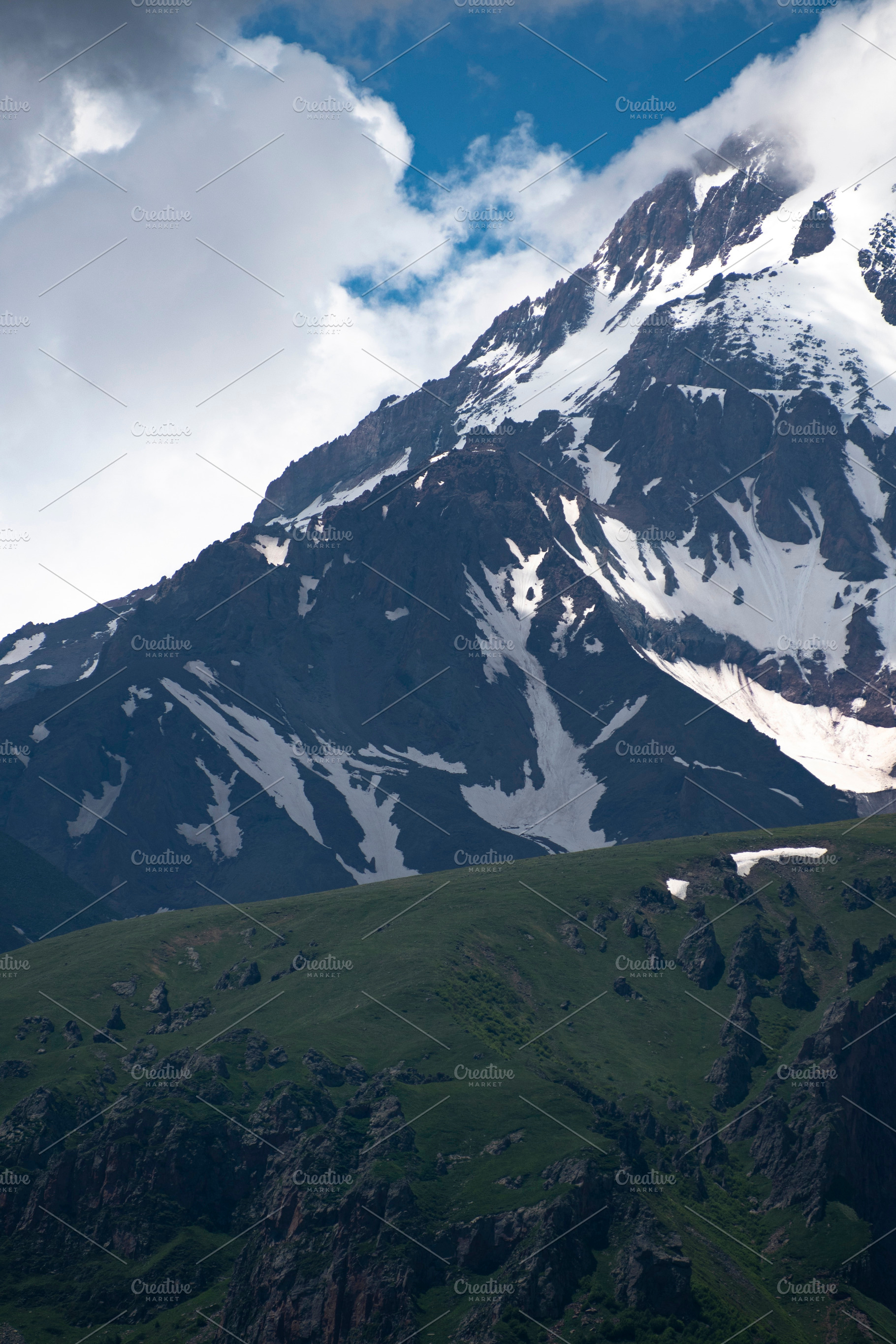 Vertical view of green hills and snowy Mount Kazbek slopes under, a Photo by Pictures for you!!!!!!!!!