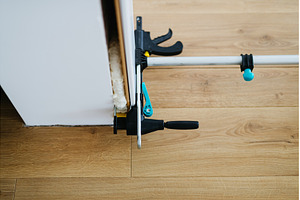 Close up on clamps on door frame, an Architecture Photo by HalfPoint