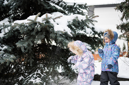 Children play outdoors in snow. Two little sisters near Christma, a Person Photo by AS photostudio