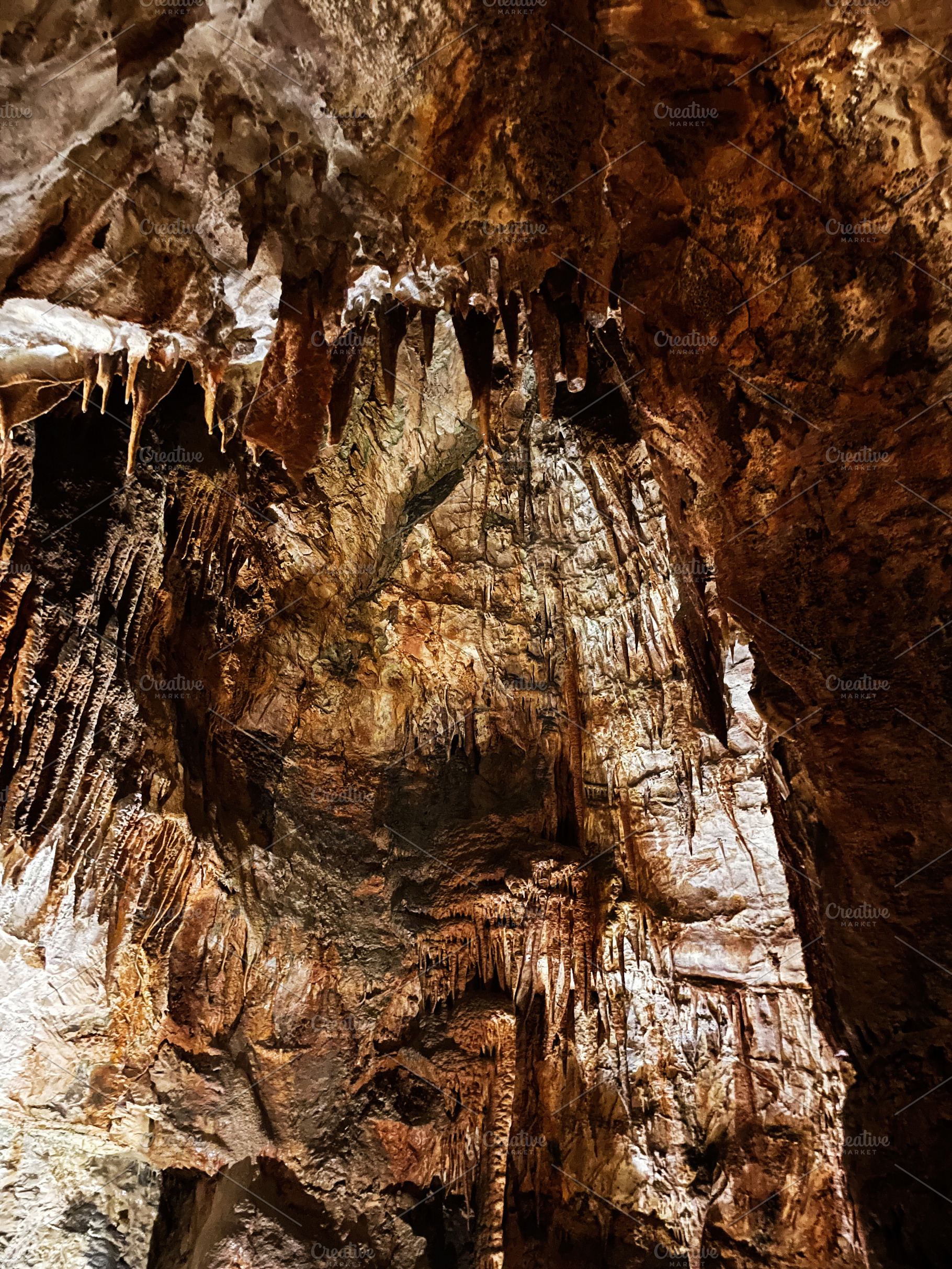 Stunning stalactites and stalagmites inside a cave in a natural rock formation, a Photo by AS photostudio