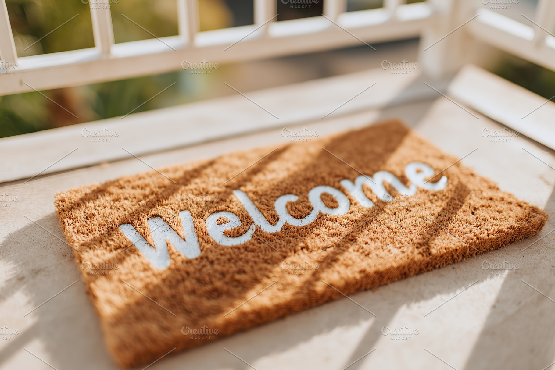 Cozy welcome mat placed at the entrance of a sunny balcony in the afternoon, a Background Photo by AlyaAnd