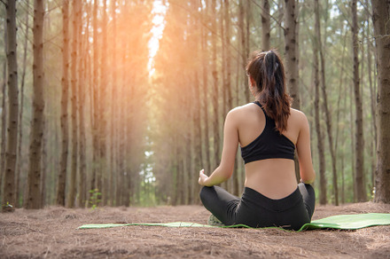 Beautiful Asian young woman lying on green mat and doing yoga in, a Sports & Recreation Photo by Ministocker