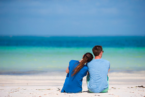 Young family on white beach during summer vacation featuring adult, beach