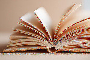 Close-up view of a blank open book with soft pages in a neutral setting, a Photo by AlyaAnd