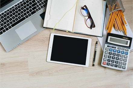 Work office desk table with laptop tablet supplies and calculator top view, a Business Photo by ok_kate