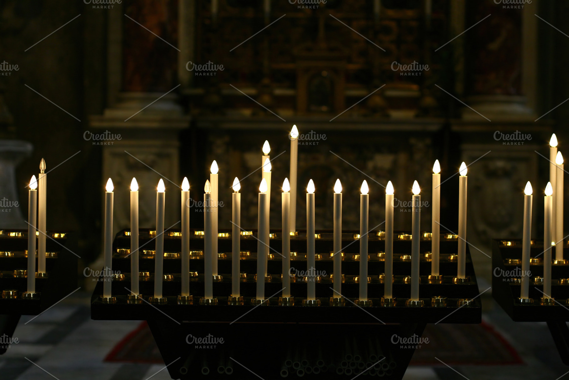 Burning electric candles lighting up a church interior, an Abstract Photo by Antonio Gravante Market