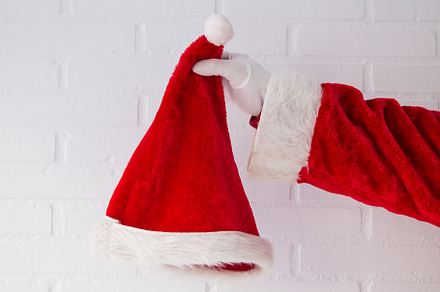 Santa claus hand holding hat on whit featuring christmas, holiday, and costume