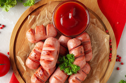 Concept of tasty food, grilled mini sausage, top view, a Background Photo by AtlasStudio