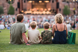 Family enjoying outdoor concert on g, a Photo by Pixeness Studio