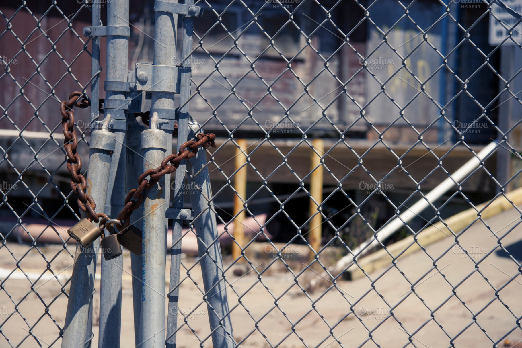 Padlock on chain link photo featuring chain link, fence, and padlock, an Industrial Photo by Tien Frogget