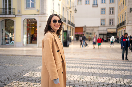 Happy caucasian girl walking city street on sunny autumn day, a Person Photo by andreonegin market