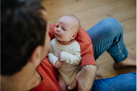 Close-up of father holding his, a Person Photo by HalfPoint