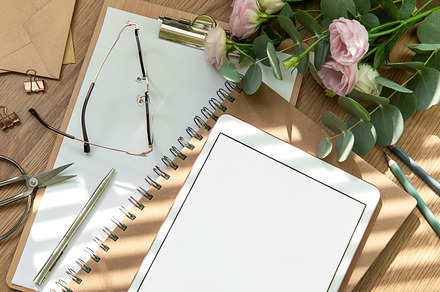 Stationery workspace with a blank tablet, notebook, and flowers, a School & Education Photo by Olena Rudo